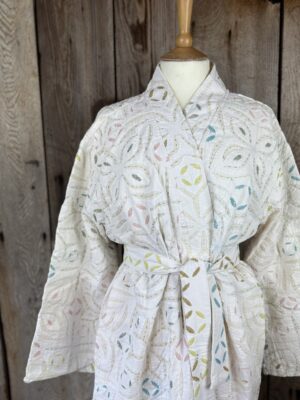 A luxury white dressing gown made using the traditional Indian technique of Cutwork. Additional hand embroidery in pastel shades.
