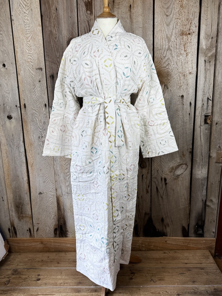 A luxury white dressing gown made using the traditional Indian technique of Cutwork. Additional hand embroidery in pastel shades.