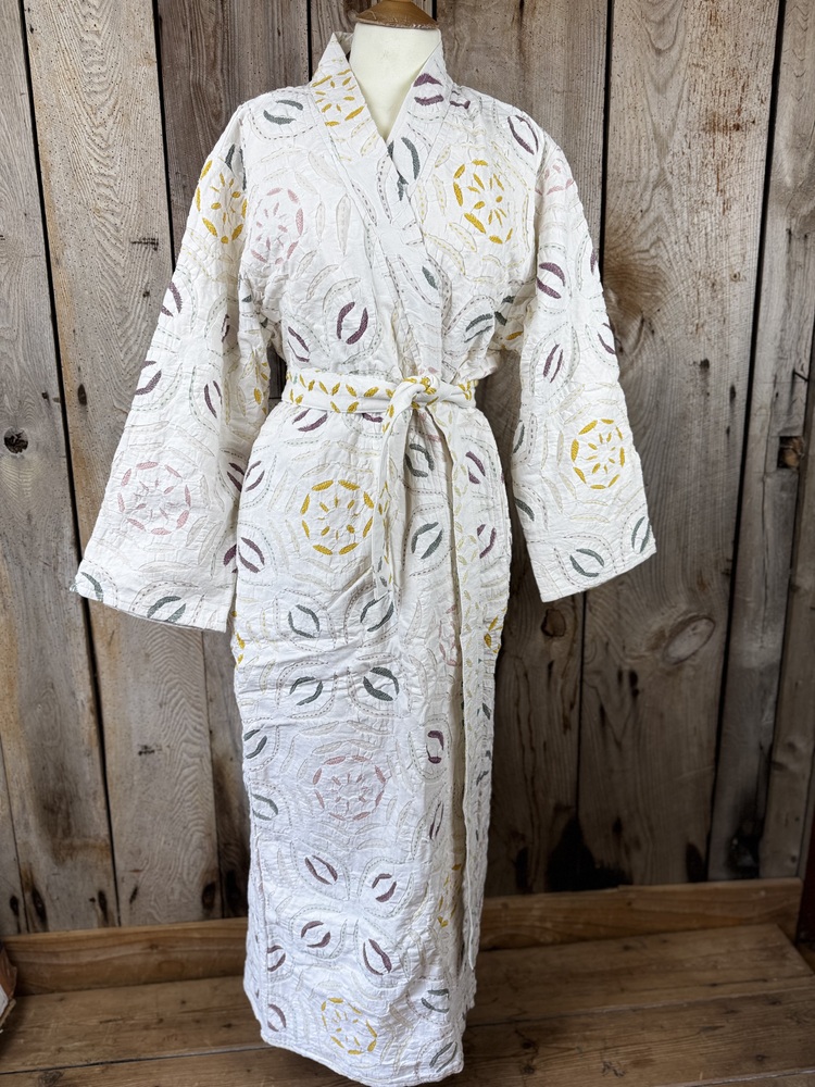 A luxury white dressing gown made using the traditional Indian technique of Cutwork. Additional hand embroidery in pastel shades.