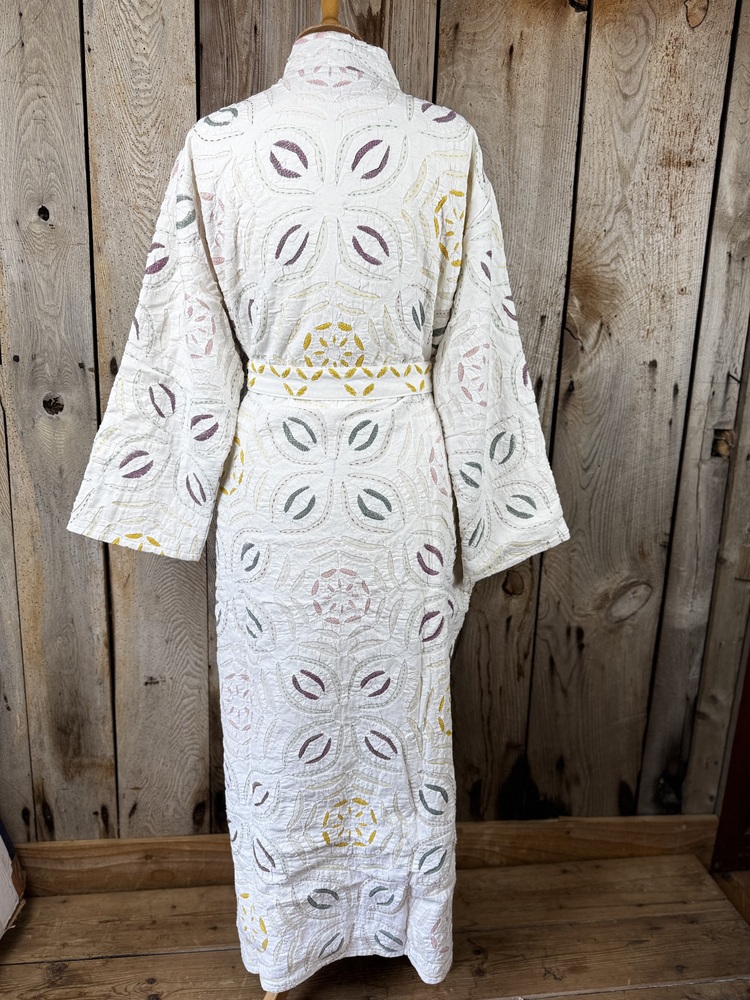 A luxury white dressing gown made using the traditional Indian technique of Cutwork. Additional hand embroidery in pastel shades.