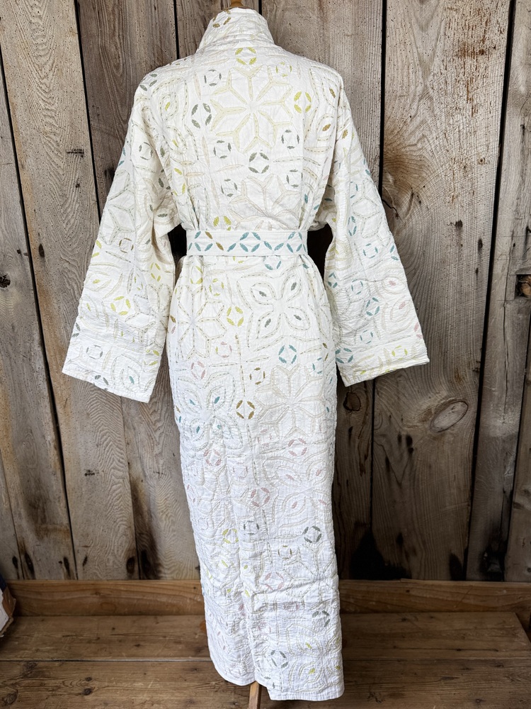 A luxury white dressing gown made using the traditional Indian technique of Cutwork. Additional hand embroidery in pastel shades.