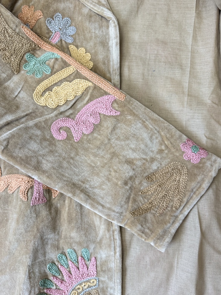 Hand embroidered cotton velvet jacket with soft texture, cosy easy fit, and intricate artisanal detailing.